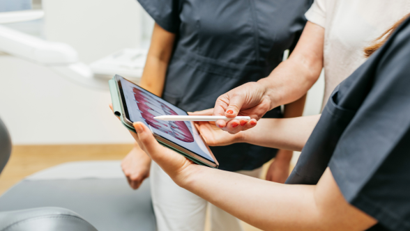 Tres personas mirando atentamente una tableta