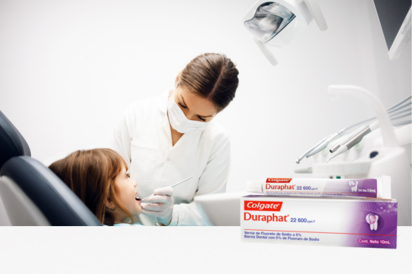 Una niña recibe una limpieza dental por parte de su dentista, rodeada de instrumentos odontológicos y de un acogedor entorno clínico.